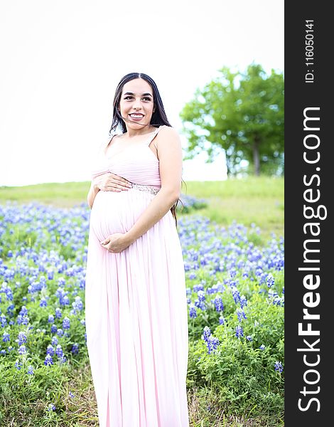 Pregnant Wearing Pink Dress Surrounded With Lavender