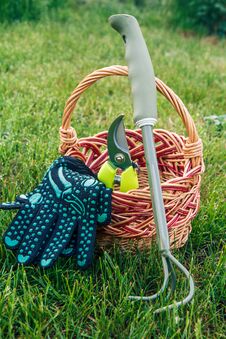 Small Hand Garden Rake, Pruner And Gloves With Wicker Basket In Stock Images