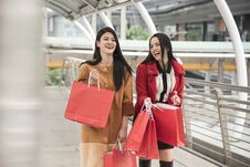 Beautiful Girls Holding Shopping Bags Walking At Shopping Mall Stock Image