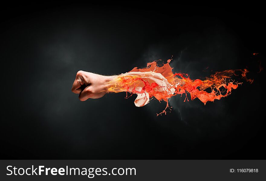 Close of male fist in fire flames. Close of male fist in fire flames