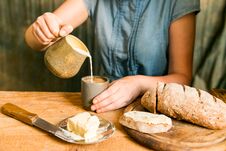Woman Has Breakfast Adds Milk To Coffee Royalty Free Stock Photos Woman Has Breakfast Adds Milk To Coffee Royalty Free Stock Photos