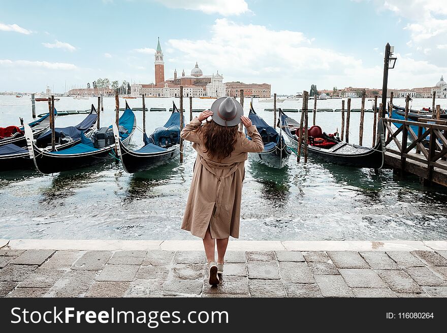 Young woman in a hat on a background of water in Venice. Young woman in a hat on a background of water in Venice