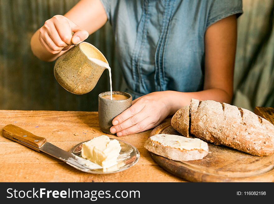 Woman Has Breakfast Adds Milk To Coffee