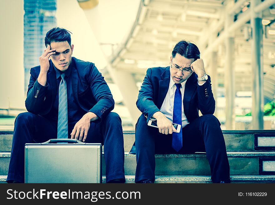 Two asian Businessman feel sad and frustrated upset fail in life.