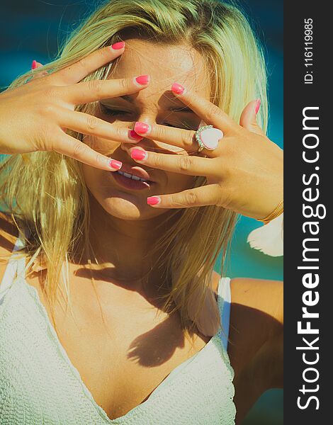 Pretty young blonde pretty girl at beach cover head with hands. Woman fashion have active time in summer. Summertime carefree concept. Pretty young blonde pretty girl at beach cover head with hands. Woman fashion have active time in summer. Summertime carefree concept.