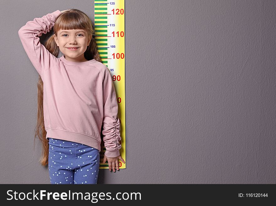 Little Girl Measuring Her Height
