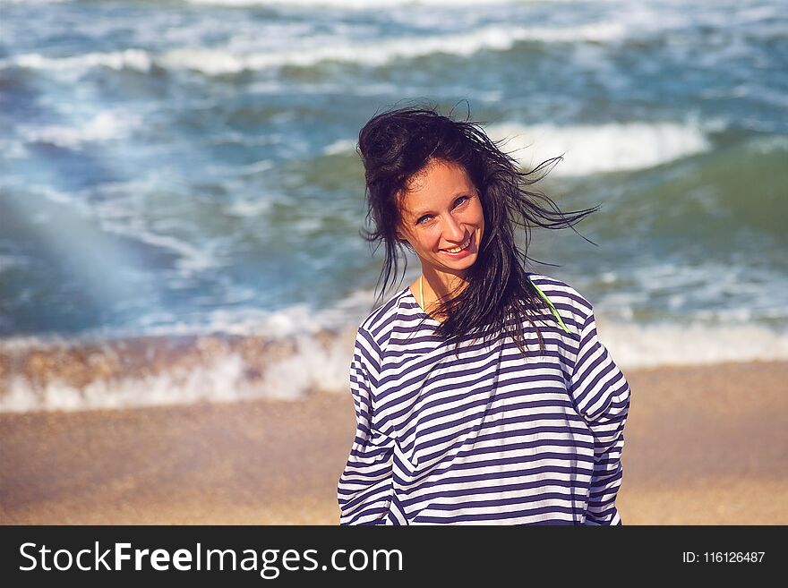 Cheerful woman on the beach, beautiful portrait.