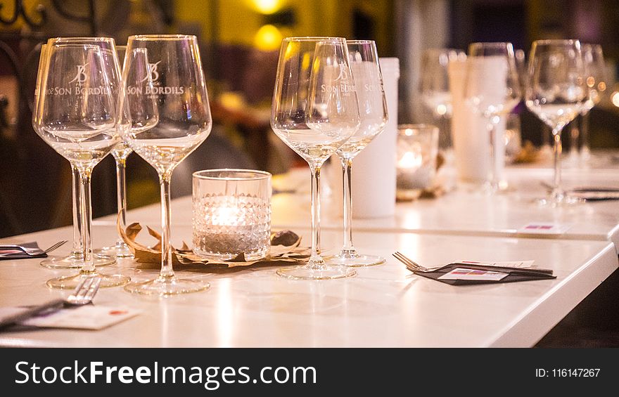 Clear Wine Glasses on White Wooden Table