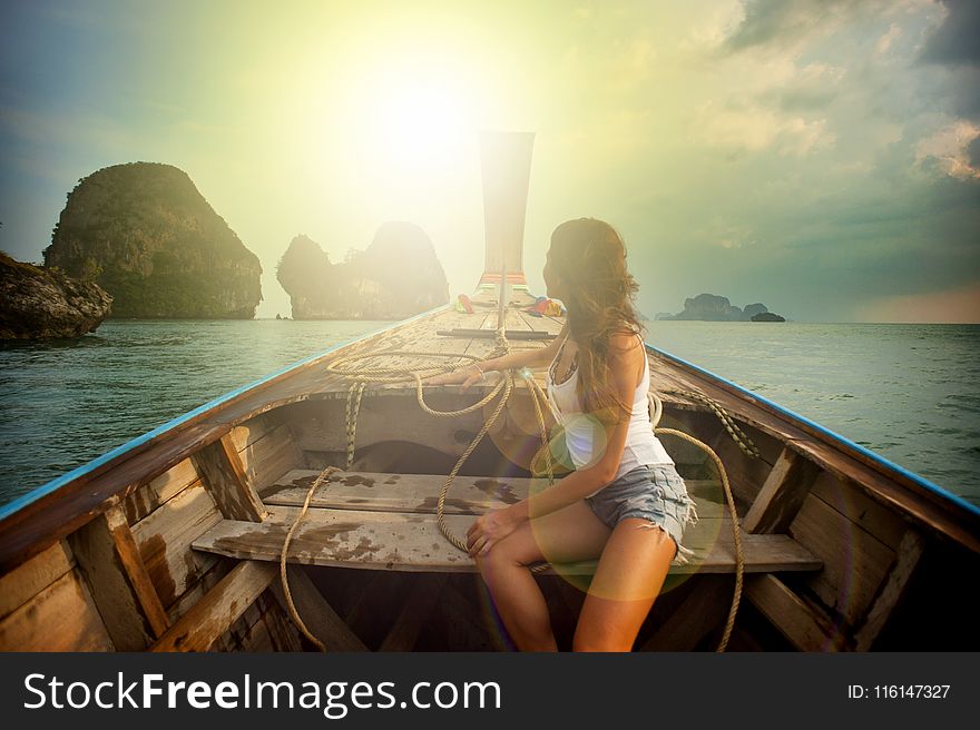 Woman Wearing White Tank Top Seating On Boat