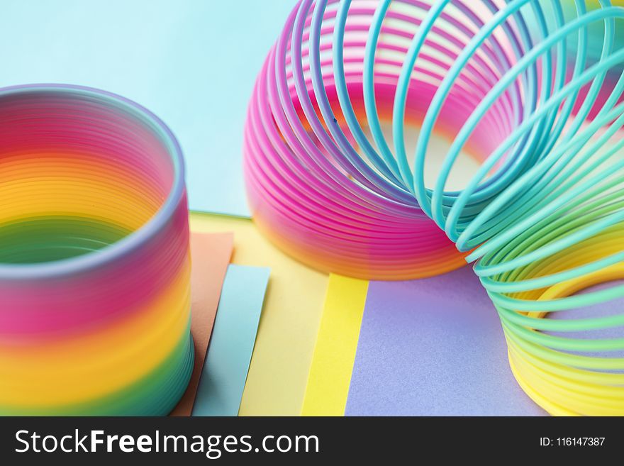 Two Multicolored Slinky Toys
