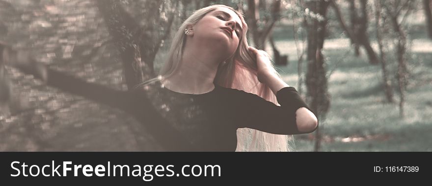 Woman Wearing Black Long-sleeved Shirt Near Trees