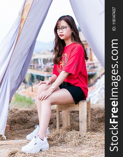 Woman in Red T-shirt and Black Denim Shorts