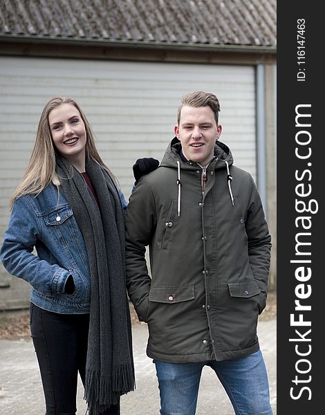 Man Wearing Black Coat And Woman Wearing Blue Denim Jacket