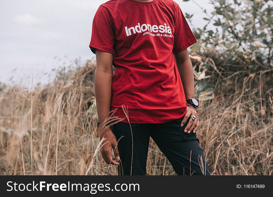 Man in Red Crew-neck T-shirt Beside Grasses