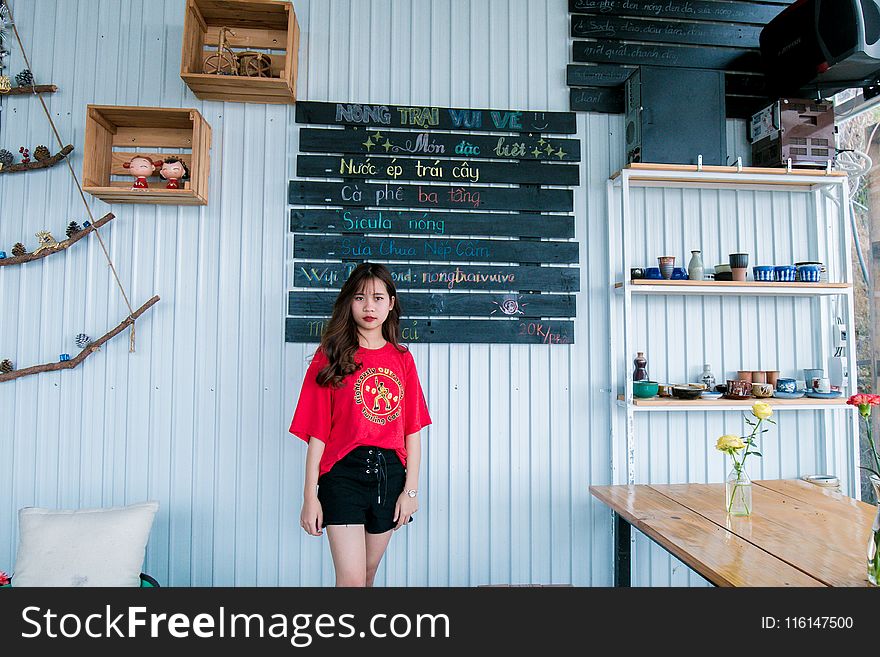 Woman In Red Crew-neck T-shirt And Black Short Shorts