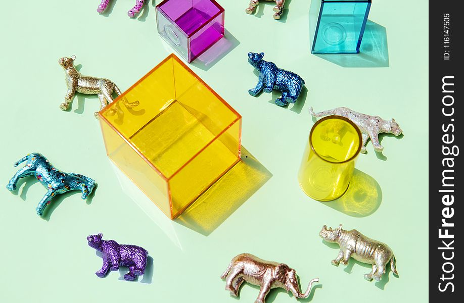 Assorted-color Animal Figurines Near Container