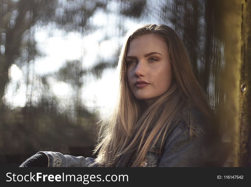 Woman Wearing Gray Denim Jacket By The Wall