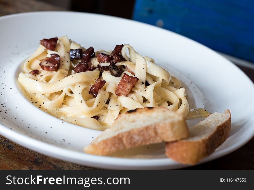 Pasta Dish With Bread on White Ceramic Plate
