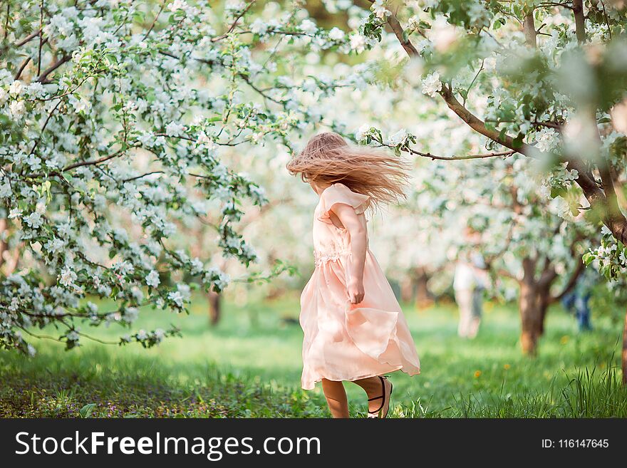 Cute Girl In Blooming Apple Tree Garden Enjoy The Warm Day