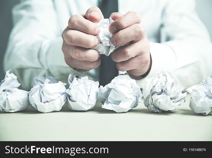 Crumpled paper on man hands. Business concept