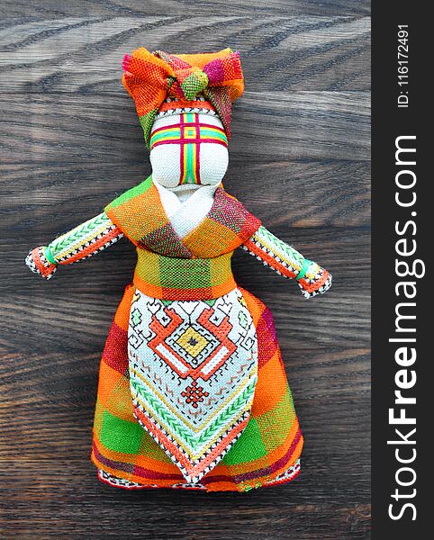 Motanka doll on the wooden background for your design