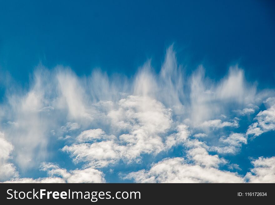 White color clouds found in the blue sky background