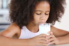 Curly African-American Girl Drinking Milk Stock Photos