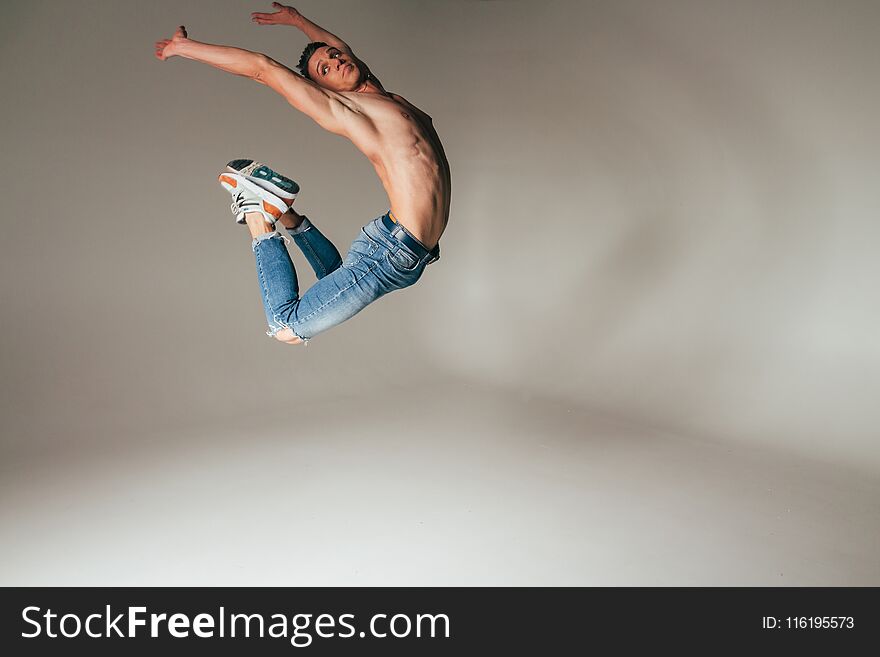 Shot of mad, crazy, cheerful, successful, lucky guy in casual outfit, jeans, jumping with hands up,triumphant, gesturing against w