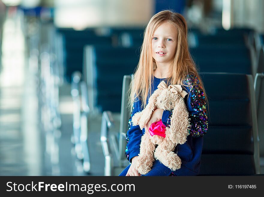 Little Adorable Girl In Airport Near Big Window With Her Favourite Toy Ready For Travel