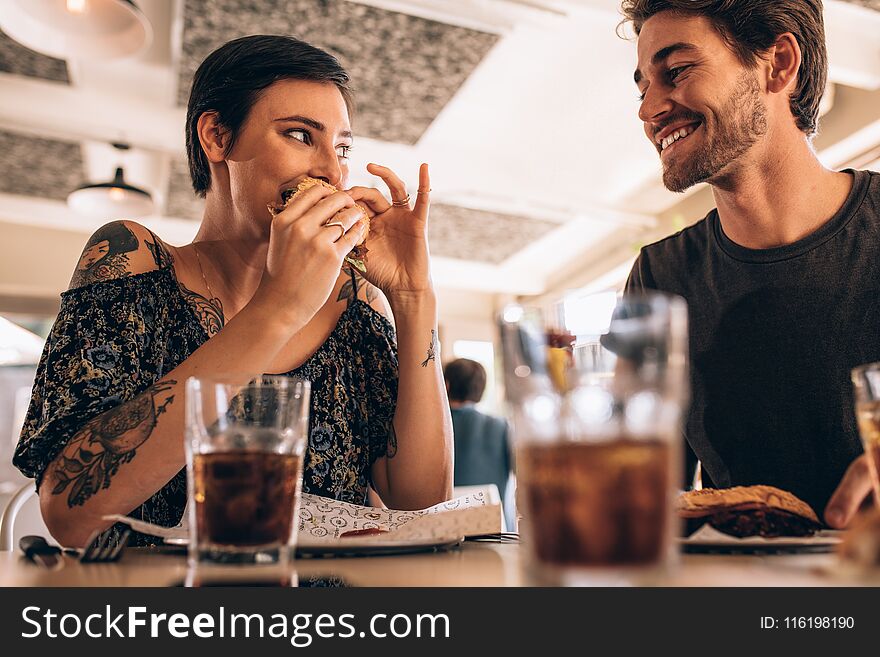 Couple at restaurant having burger