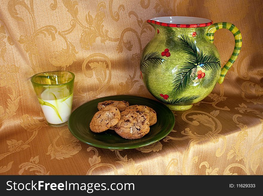 A plate of chocolate chip cookies, a pitcher and glass of milk for Santa Claus. A plate of chocolate chip cookies, a pitcher and glass of milk for Santa Claus.