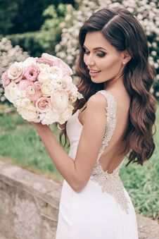 Beautiful Bride With Dark Hair In Luxurious Wedding Dress With Tender Wedding Bouquet Stock Photos