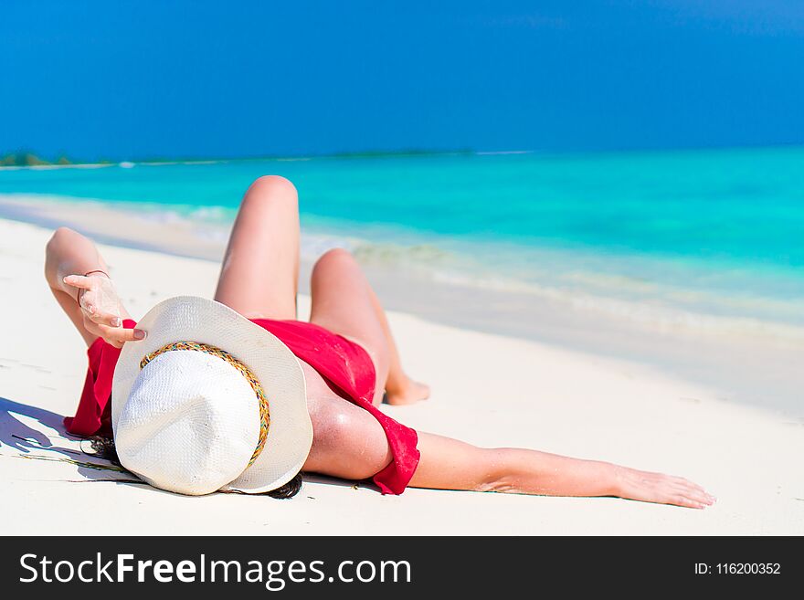 Young Beautiful Girl Lying On Snow White Tropical Beach