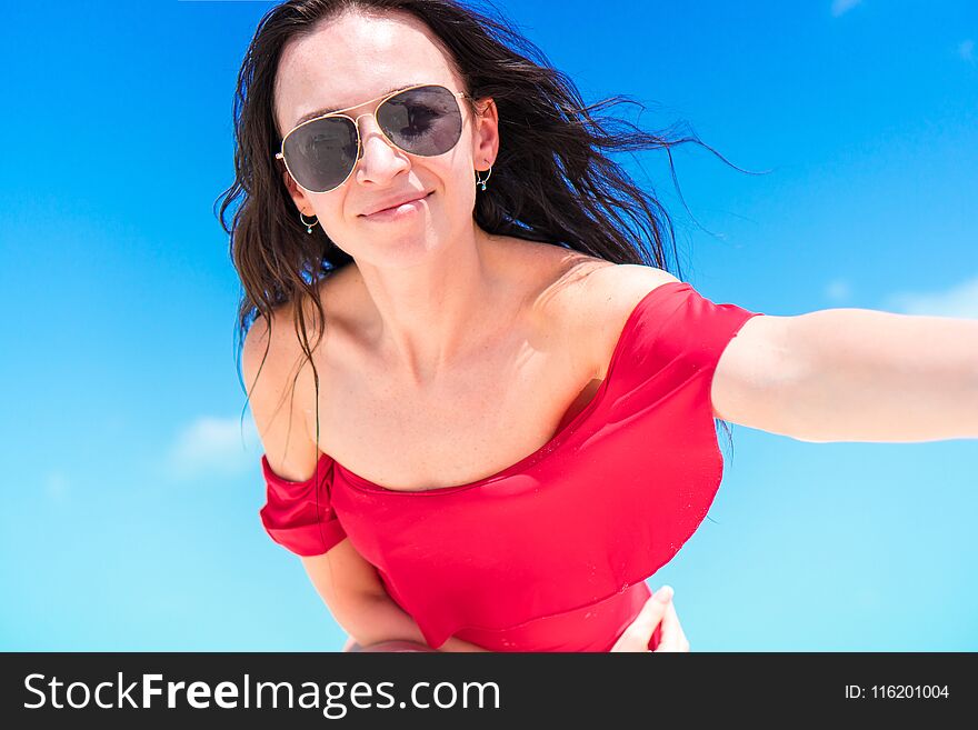 Young happy woman in swimsuit on white beach. Young happy woman in swimsuit on white beach