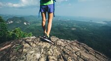 Woman Hiker Stand On Mountain Peak Cliff Edge Royalty Free Stock Photography