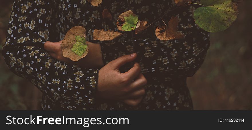 Photo of Person Wearing Black and White Floral Long-sleeved Shirt With Leaves All over in Top