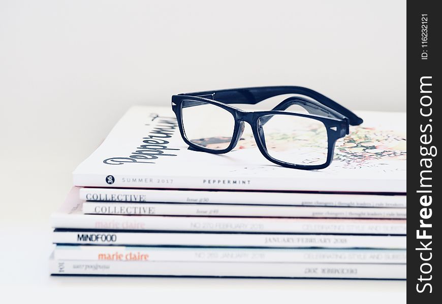 Black Framed Eyeglasses on Seven Collective Books