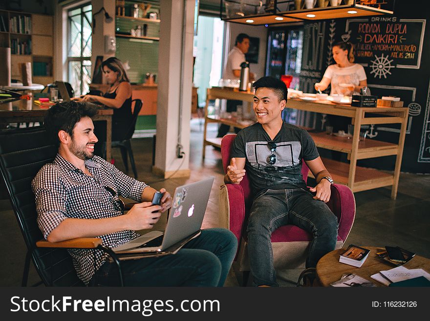 Photograph Of Men Having Conversation Seating On Chair