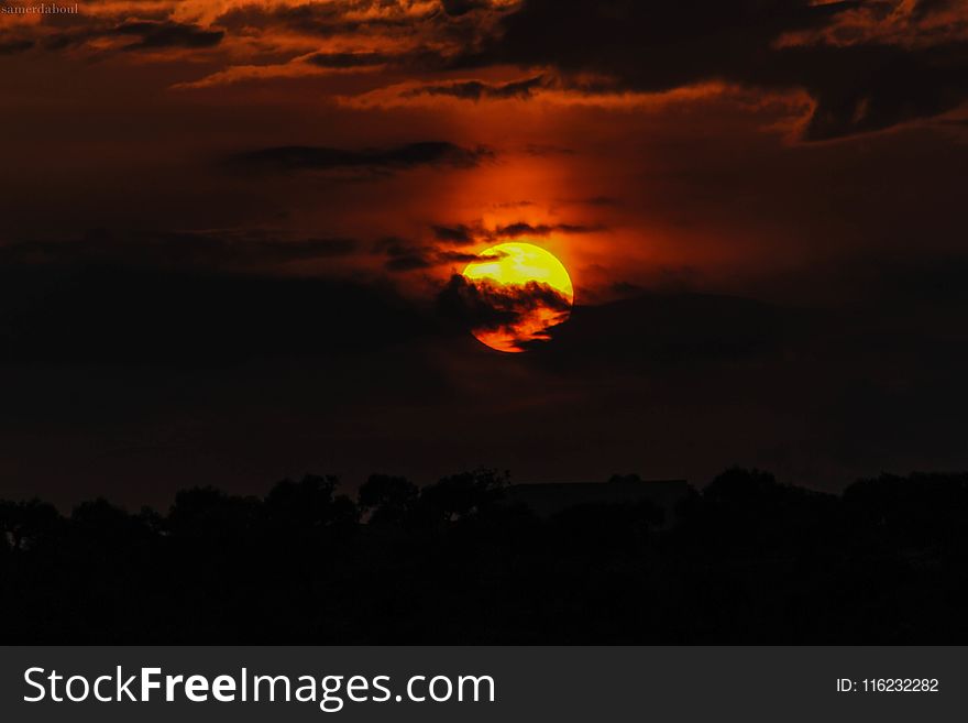 Orange Sun Hiding On Clouds