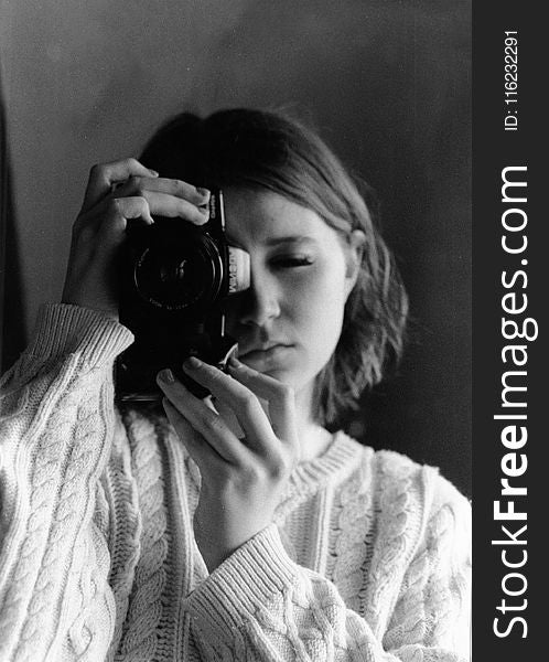 Grayscale Photography Of Woman Holding Camera