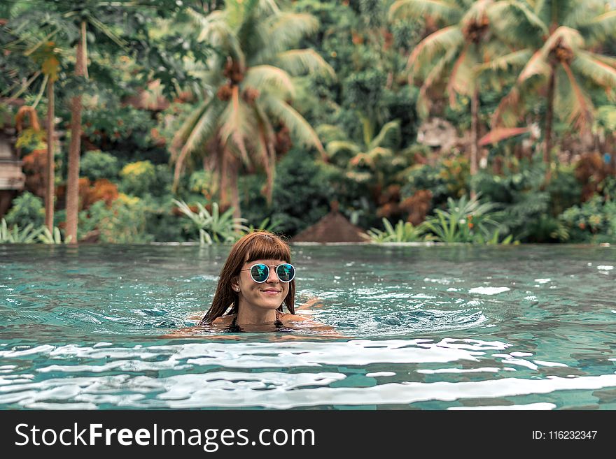 Woman Swimming Wearing Green Sunglasses
