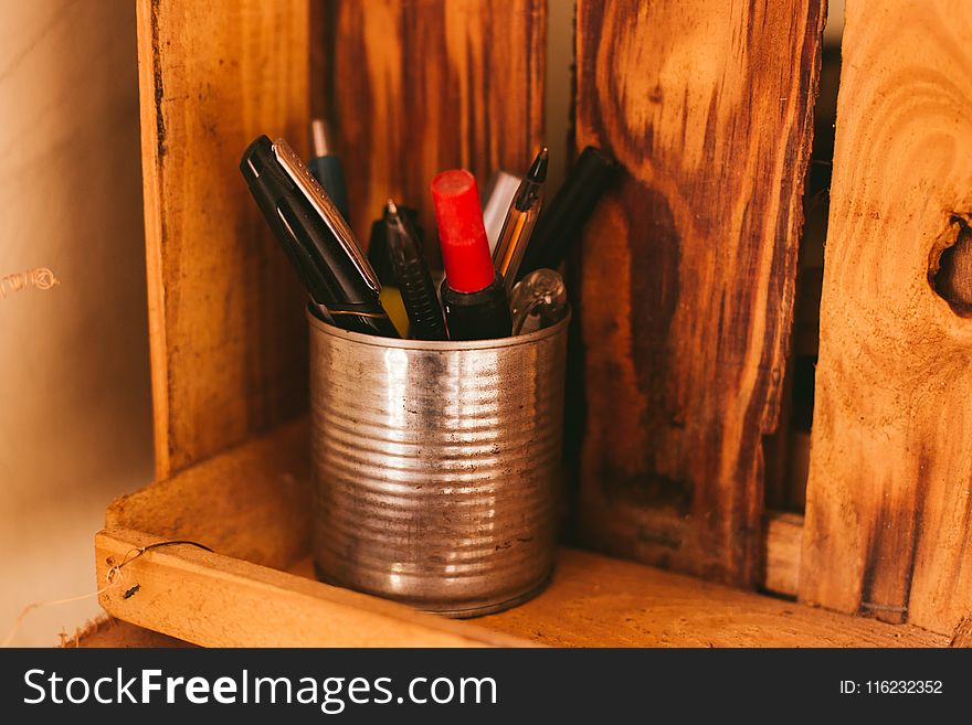 Selective Focus Photography Of Pens In Silver Can