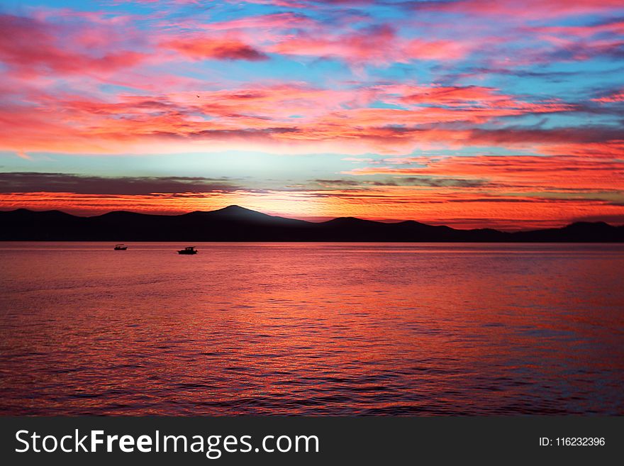 Body Of Water During Sunset