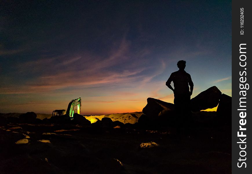 Silhouette Photo Of Person Standing Near The Rock