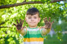A Young Caucasian Boy Showing Off His Dirty Hands After Playing Stock Photo