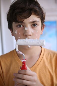 Smiling Teenager Boy With White Paint Roller And Dirty Face Make Repaint Stock Images