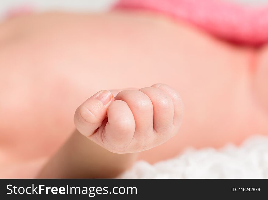 Closeup portrait little baby hands background on the bed. Closeup portrait little baby hands background on the bed