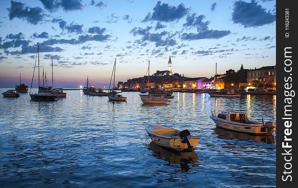 Night View Of Beautiful Town Rovinj In Istria, Croatia. Evening In Old Croatian City, Night Scene With Water Reflections