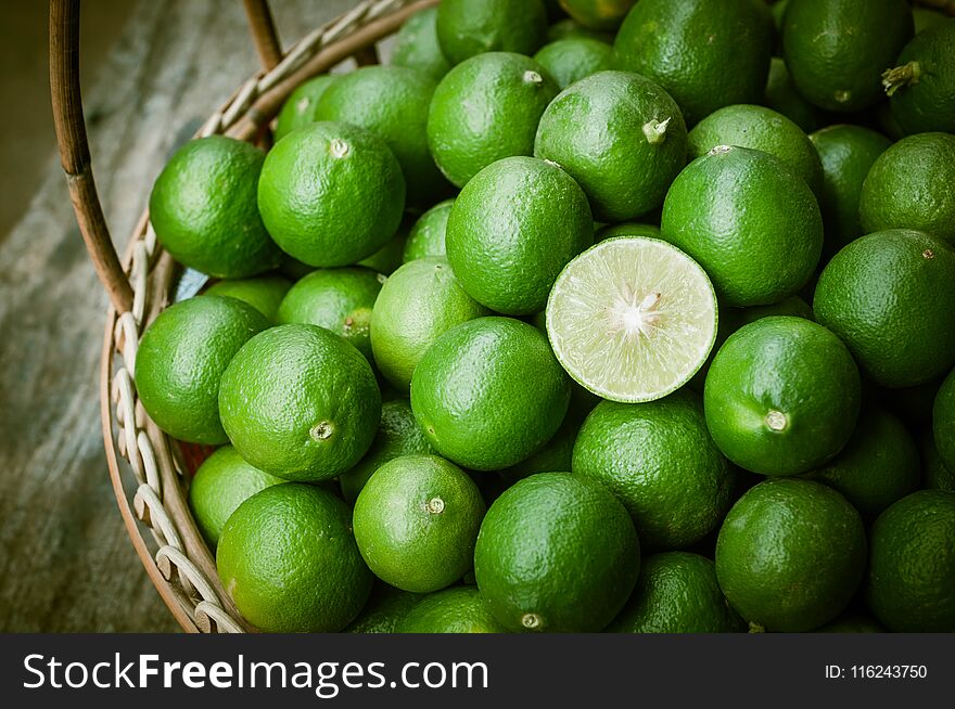 Closeup of green lemon on rattan basket, vegetable ingredient for food. Closeup of green lemon on rattan basket, vegetable ingredient for food