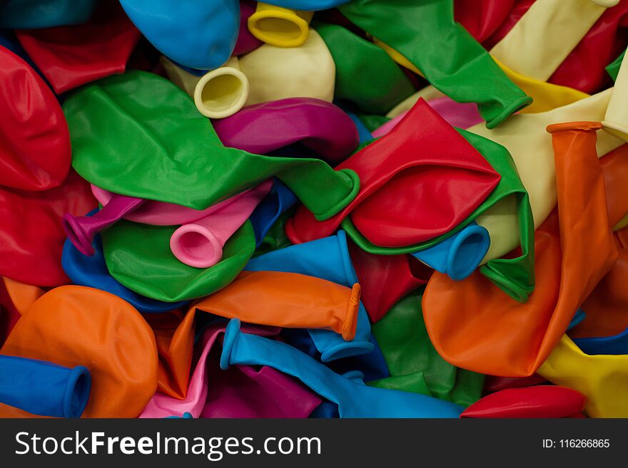 Colorful balloons and confetti on blue table top view. Festive or party background. Flat lay style. Copy space for text. Birthday greeting card.Selective focus